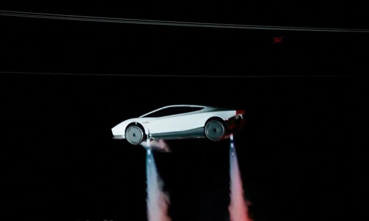 Elon Musk Unveils Flying Car, Demonstrates Tesla Roadster Driving Upside Down on Curved Ramp, Leaping into the Air, Performing a Flip and Landing on Its Wheels (Image 3)